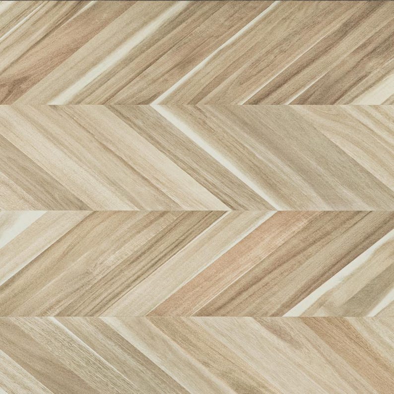 May include: A light brown wood surface featuring a repeating chevron pattern. The planks display natural grain variations in shades of tan, beige, and cream, arranged in a diagonal zigzag formation that creates a continuous geometric texture.