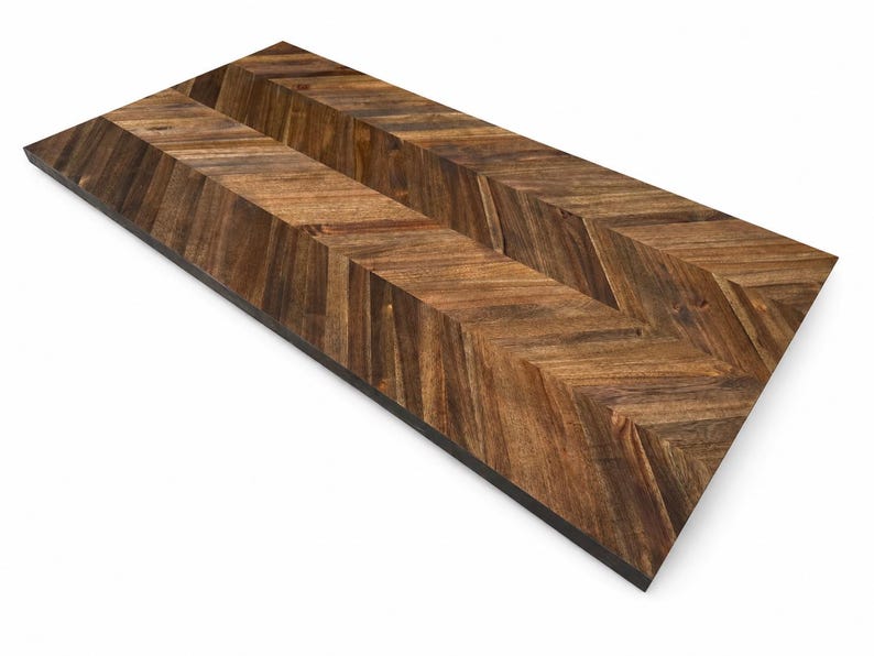 May include: A rectangular wooden board featuring a dark brown chevron pattern. The surface displays natural wood grain variations with alternating light and dark brown tones arranged in a V-shaped design across the entire flat top surface.