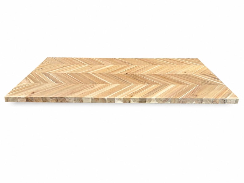 May include: A rectangular wooden board featuring a light brown herringbone pattern. The surface displays natural wood grain variations with alternating angled slats, creating a consistent geometric design across the entire flat top surface.