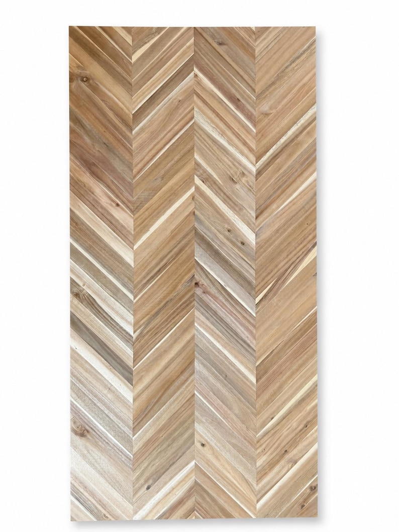 May include: A rectangular wooden panel featuring a natural light brown finish with a prominent herringbone pattern. The surface displays visible wood grain, knots, and variations in color ranging from tan to dark brown, arranged in a vertical chevron design.