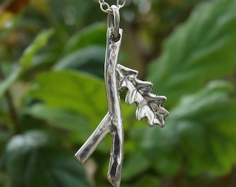 Handcrafted oakleaf & twig pendant in sterling silver symbolising strength and courage.  Created from silver sheet and wire in Cornwall, UK.