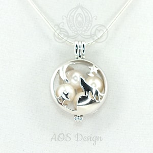 May include: Silver necklace with a round charm featuring a wolf howling at the moon with stars and pearls inside. The charm is open and can be used as a locket.