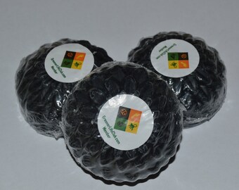 May include: Three black soap bars wrapped in plastic with a white label that says "GreenerLifeClub.com Member" and has a green, yellow, orange, and red logo with a lion, a fish, a bird, and a monkey on it.