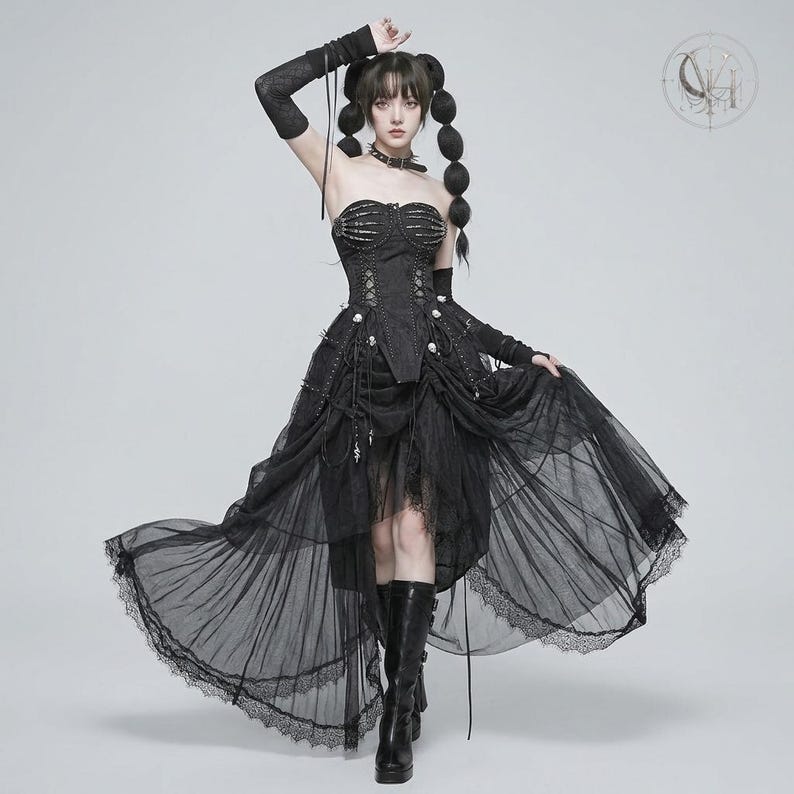 May include: A black strapless corset dress featuring a skeletal rib cage design on the bodice, a lace-up front, and a layered tulle high-low skirt with lace trim. The outfit includes matching black arm warmers and a choker, paired with black boots.