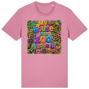 May include: A heather pink t-shirt featuring a colourful graphic print of various reptiles, insects, and tropical flowers surrounding the text "My house is a ZOO, I Love it!" in bold, multi-coloured lettering centred on the front of the garment.