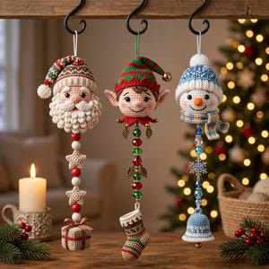 May include: Three crocheted Christmas ornaments hanging from black hooks. The first is a Santa Claus with a gift box, the second is an elf with a stocking, and the third is a snowman with a bell. Each features colorful beads and festive details.