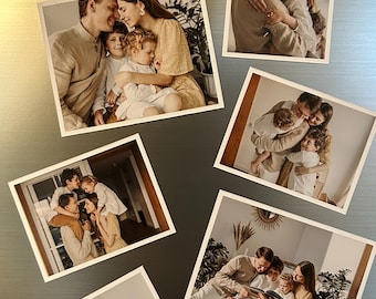 May include: Five square and rectangular photo magnets featuring various candid family portraits. Each image displays a group of two adults and two children in neutral-toned clothing, captured in indoor settings with soft lighting and natural greenery.