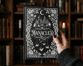 Libro ilustrado de coleccionista de Manacled en tapa dura: edición completa con láminas y marcapáginas.