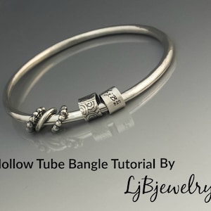 May include: A silver hollow tube bangle bracelet with a silver knot charm and two silver rings. The rings have a textured design and one ring has the text "M.B. 925" engraved on it.