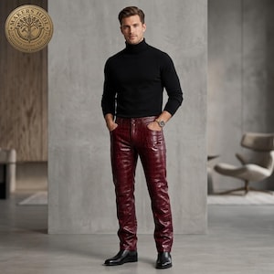 May include: A black long-sleeved turtleneck jumper paired with deep burgundy trousers featuring a textured crocodile-skin pattern. The trousers have a classic five-pocket design with metal rivets and a button fly closure, worn with black leather boots.