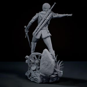 May include: A grey monochromatic figurine of a warrior standing on a rocky base with a wagon wheel. The figure wears textured armour, carries a sword in one hand, and has a second sword sheathed on their back, with one arm extended outwards.
