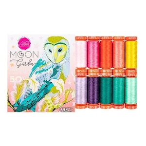 May include: A Tula Pink Moon Garden thread set featuring a square box with an owl illustration and the text Moon Garden. Next to the box are ten spools of Aurifil 100% cotton thread in various colors including pink, orange, yellow, purple, and green.