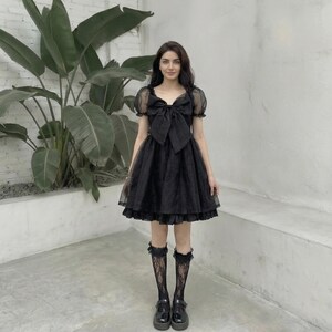 black puff sleeve babydoll dress WOWARKI Womens Square Neck Smocked Dress Tiered Ruffle Puff Sleeve Mini Babydoll Dress Flowy Summer Dress A Line Short Dresses (Black, S) at Amazon Women's Clothing store