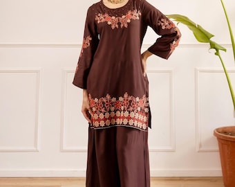 May include: A dark brown long-sleeved tunic and wide-leg trousers set featuring intricate floral embroidery in shades of orange, red, and cream along the neckline, sleeves, and hemline of both the tunic and the trousers, creating a cohesive look.