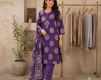 May include: A deep purple three-piece outfit consisting of a long-sleeved tunic with a white circular mandala print, matching straight-leg trousers, and a coordinating rectangular scarf featuring a geometric pattern and a tasseled drawstring neck.