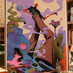 May include: A framed rectangular art print featuring a stylized figure with long brown trousers and a dark top, surrounded by surreal purple clouds, pink and blue spheres, green organic shapes, and a pink mushroom-like structure on a tan background.