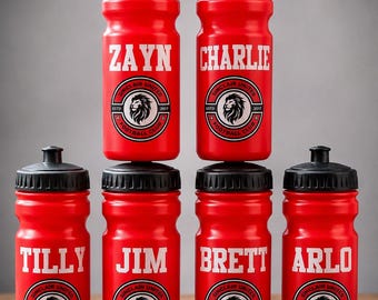 May include: Six bright red plastic sports water bottles with black screw-on caps. Each bottle features a white printed name, including ZAYN, CHARLIE, TILLY, JIM, BRETT, and ARLO, above a circular Sinclair United Football Club logo with a lion head.