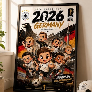 May include: A framed poster featuring a FIFA World Cup 2026 Germany theme with chibi-style soccer players in white and black jerseys. The design includes the German eagle, the Berlin TV tower, a soccer ball, and text reading "GEMEINSAM FÜR DEUTSCHLAND!"