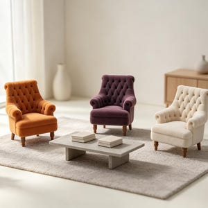 May include: Three miniature armchairs in orange, deep purple, and cream, each featuring a tufted backrest, rolled arms, and dark wooden legs. A rectangular gray coffee table sits in the center, holding two small square items on its surface.