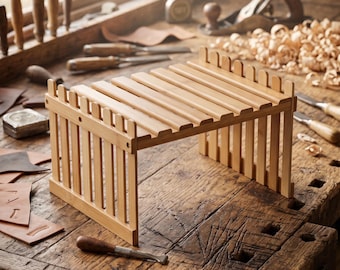May include: A light-coloured wooden shelf featuring a slatted top surface and vertical picket-style side panels. The structure is rectangular with a fence-like design, constructed from smooth, natural-toned wood slats arranged in a parallel pattern.
