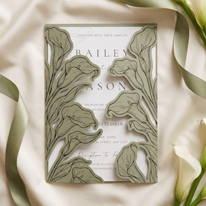 May include: A rectangular wedding invitation card featuring a sage green laser-cut cover with a detailed calla lily floral pattern. The white inner card displays black text including the names Bailey and Mason, event details, and a date in September.