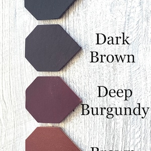 May include: Four leather samples in different colors: black, dark brown, deep burgundy, and brown. Each sample is shaped like an octagon.