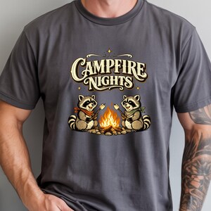 Retro illustration of two raccoons wearing bandanas roasting marshmallows over a campfire with the text Campfire Nights above them on a cream background. — product photo 11