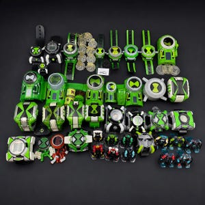 May include: A collection of Ben 10 Omnitrix toy watches and accessories in various shades of green, black, and white. The set includes multiple wrist-worn devices, small circular discs, and miniature action figures arranged on a dark surface.