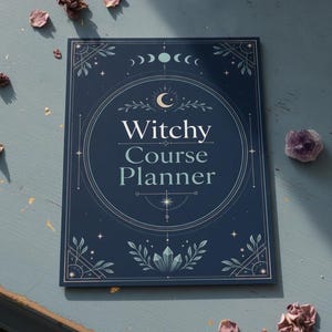 May include: A dark blue rectangular planner with the text Witchy Course Planner printed in white. The cover features a central crescent moon, a lunar cycle graphic at the top, and decorative botanical and crystal illustrations in white and light blue.