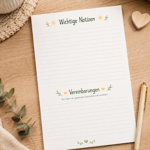 May include: A white notepad with horizontal lines featuring the green text Wichtige Notizen at the top, decorated with yellow sun icons. The middle section displays the text Vereinbarungen and Das haben wir gemeinsam besprochen und vereinbart.