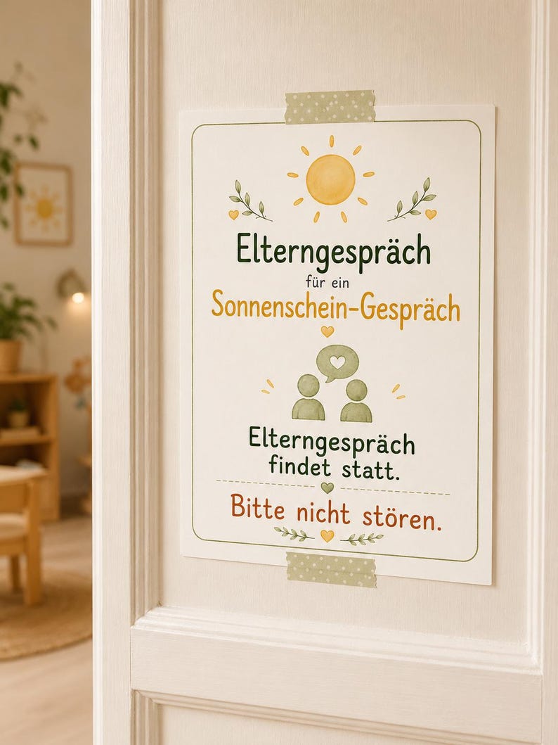 May include: A rectangular white sign taped to a door with green and yellow illustrations of a sun, leaves, hearts, and two figures. The text reads: "Elterngespr&auml;ch f&uuml;r ein Sonnenschein-Gespr&auml;ch", "Elterngespr&auml;ch findet statt.", and "Bitte nicht st&ouml;ren."