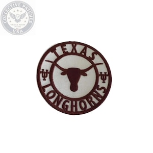 May include: A circular embroidered patch featuring a white background with a dark maroon border. The text TEXAS LONGHORNS is stitched in maroon around the center, which displays a maroon longhorn steer silhouette and two small trident symbols.