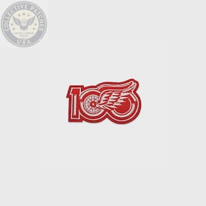 May include: An embroidered patch featuring the number 100 in red and white thread. The design incorporates a stylized winged wheel graphic integrated into the zeros, with a white border outlining the entire shape of the commemorative emblem.