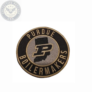 May include: A circular embroidered patch featuring a black border with the gold text PURDUE BOILERMAKERS. The center displays a grey silhouette of the state of Indiana with a large black and gold letter P logo centered over the state shape.
