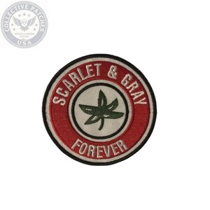 May include: A circular embroidered patch featuring a red border with the white text SCARLET & GRAY FOREVER. The center is a cream-colored circle containing a dark green leaf graphic. The entire patch is outlined with a thin black stitched border.