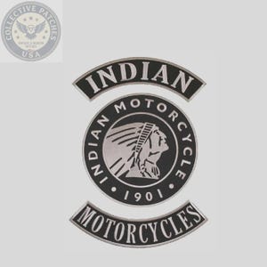 May include: A black and silver embroidered patch featuring the Indian Motorcycle logo. The design includes a central circular emblem with a profile of a Native American figure, the text INDIAN MOTORCYCLE 1901, and two curved banners reading INDIAN and MOTORCYCLES.