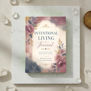 May include: A hardcover journal with a cream-colored center panel featuring the text "INTENTIONAL LIVING Journal, QUIET REFLECTION, PURPOSEFUL LIVING. Rediscover You. Live with Intention." surrounded by watercolor floral illustrations in pink and blue.