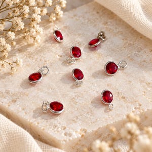 Pingente delicado redondo em prata de lei 925 com zircônia cúbica vermelha, ideal para joias minimalistas e para confecção de bijuterias.