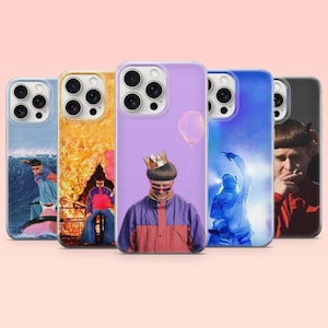 May include: A collection of five smartphone cases featuring various photographic prints of a person with a bowl-cut hairstyle. The designs include a surfer on a wave, a person in front of fire, a person wearing a crown, a person in blue light, and a portrait.