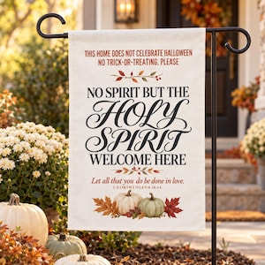 May include: A rectangular off-white garden flag featuring the text THIS HOME DOES NOT CELEBRATE HALLOWEEN NO TRICK-OR-TREATING, PLEASE, NO SPIRIT BUT THE HOLY SPIRIT WELCOME HERE, and Let all that you do be done in love. 1 CORINTHIANS 16:14 with pumpkins.