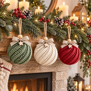 May include: Three round Christmas baubles with a textured, spiral-knit pattern in sage green, cream, and deep red. Each bauble features a natural jute twine loop, a light wooden bead, a beige fabric bow, and a small wooden star charm.