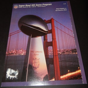 May include: A vintage Super Bowl XIX game program featuring a photo of the Vince Lombardi Trophy in front of the Golden Gate Bridge. The program cover is purple and features the text "Super Bowl XIX Game Program" and "Miami Dolphins vs. San Francisco 49ers".