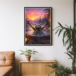 May include: A framed wall art print depicting a raccoon soaking in a wooden hot tub at sunset. The raccoon holds a wine glass in one hand and a wine bottle in the other. The scene features a mountain forest background, string lights, and a lantern.