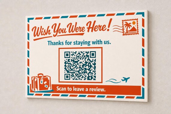 Postcard Farewell multicolor landscape review sign mounted on a neutral wall from a close side angle with a finished sample QR code.