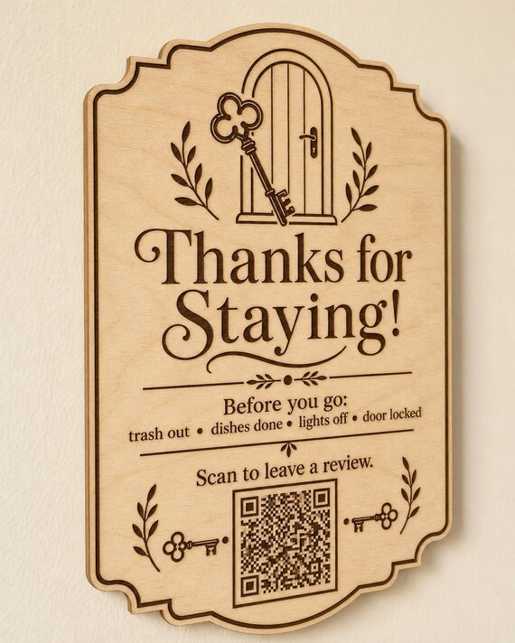 HearthKey engraved birch review sign mounted on a cream wall from a close side angle, with a finished sample QR code.