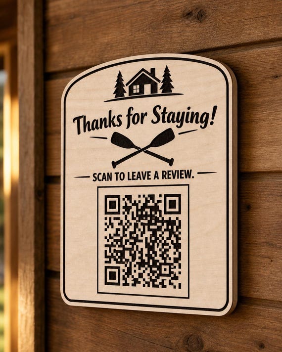 LakeTrail engraved birch paddle review sign mounted on a warm wall from a close side angle with a finished sample QR code.