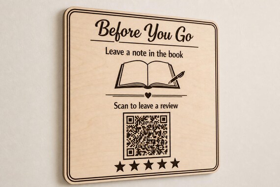 Guestbook Glow engraved birch review sign mounted on a neutral wall from a close side angle with a finished sample QR code.