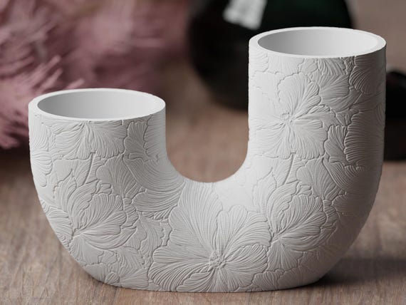 Close-up front view of the Hibiscus Bloom TwinBloom Floral Vase and its broad botanical relief
