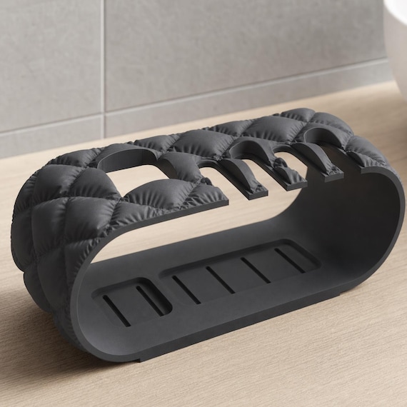 Close-up Charcoal Brushbay Five-Slot Caddy organizer showing its quilted end and slotted platform