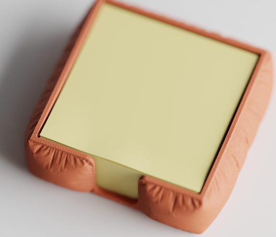 High-angle close-up of the MemoNook Pad Holder square sticky note holder in Terracotta